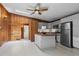 Bright kitchen features wood walls, updated stainless appliances, butcher block island, and white painted wood floor at 41 Silver Spruce, Boulder, CO 80302