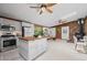 Open kitchen and living space features stainless appliances, wood trim, wood burning fireplace, and skylight at 41 Silver Spruce, Boulder, CO 80302