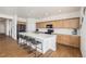 Modern kitchen with island, stainless steel appliances, and light wood cabinets at 27840 E 7Th Pl, Aurora, CO 80018