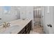 Clean bathroom featuring a double sink vanity and full shower with bright lighting at 1172 Elbridge Cir, Elizabeth, CO 80107