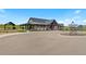 Beautiful community center with covered patios, manicured landscaping, and circular driveway at 1172 Elbridge Cir, Elizabeth, CO 80107