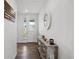 Inviting entryway with console table, mirror, and a view of the front door at 1172 Elbridge Cir, Elizabeth, CO 80107