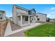 Exterior shot of a two-story home with a charming porch, complemented by a green lawn and rock landscaping at 1172 Elbridge Cir, Elizabeth, CO 80107