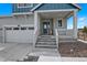 Covered front porch leads to the front door, three car garage on the left at 1172 Elbridge Cir, Elizabeth, CO 80107