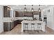 Modern kitchen with island seating, stainless steel appliances, and dark wood cabinets at 1172 Elbridge Cir, Elizabeth, CO 80107