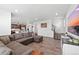Open-concept living room and kitchen area with dark wood cabinets and stainless steel appliances at 1172 Elbridge Cir, Elizabeth, CO 80107