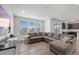 Spacious living room featuring a large sectional sofa, wood floors, and natural light at 1172 Elbridge Cir, Elizabeth, CO 80107