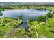 Beautiful aerial view of a lake with walking paths, lush greenery, and trees at 5583 Thunder Hill Rd, Parker, CO 80134