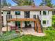 Back exterior view of a two-story home with a deck, patio, and landscaped yard at 5583 Thunder Hill Rd, Parker, CO 80134