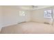 Bright bedroom featuring neutral carpet, paint, and natural light from two windows at 5583 Thunder Hill Rd, Parker, CO 80134