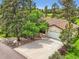Charming single Gathering home with a spacious driveway, well-manicured lawn, and mature trees at 5583 Thunder Hill Rd, Parker, CO 80134