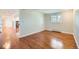 Spacious living room with hardwood floors leading to an open doorway at 5583 Thunder Hill Rd, Parker, CO 80134