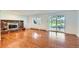 Living room with hardwood floors, a red brick fireplace, and sliding glass doors to the backyard at 5583 Thunder Hill Rd, Parker, CO 80134