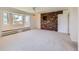 Bright living room featuring large windows with window seat and red brick feature wall at 5583 Thunder Hill Rd, Parker, CO 80134