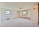 Bright living room featuring large windows with window seat and neutral carpet and paint at 5583 Thunder Hill Rd, Parker, CO 80134