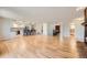 Open living space that leads to the kitchen with hardwood floors and a red accent door at 5583 Thunder Hill Rd, Parker, CO 80134