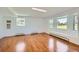 Bright living room featuring gleaming hardwood floors and a large bay window with bench seating at 5583 Thunder Hill Rd, Parker, CO 80134