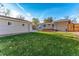 Backyard featuring a grassy area and detached garage at 5500 Holland Dr, Arvada, CO 80002