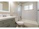 Bathroom featuring gray vanity, subway tile shower, and black and white tiled floor at 5500 Holland Dr, Arvada, CO 80002