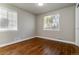 Comfortable bedroom featuring hardwood floors, fresh paint, and bright, natural light at 5500 Holland Dr, Arvada, CO 80002