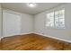 Bedroom with a large window and closet features hardwood floors at 5500 Holland Dr, Arvada, CO 80002