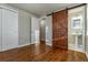 Bedroom with hardwood floors features a bathroom with a sliding barn door and a modern pedestal sink at 5500 Holland Dr, Arvada, CO 80002