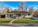 Charming ranch home featuring a well-manicured lawn and walkway leading to the front door at 5500 Holland Dr, Arvada, CO 80002
