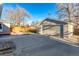 Backyard featuring a detached garage and a concrete driveway at 5500 Holland Dr, Arvada, CO 80002