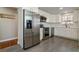 Updated kitchen with stainless steel appliances, modern cabinets, and gray tile flooring at 5500 Holland Dr, Arvada, CO 80002