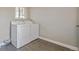 Laundry room featuring tile floors and modern washer and dryer at 5500 Holland Dr, Arvada, CO 80002