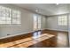 Bright living room featuring beautiful hardwood floors, fresh paint, and a door to the backyard at 5500 Holland Dr, Arvada, CO 80002