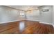 Spacious room with hardwood floors, neutral color scheme, and modern lighting fixture at 5500 Holland Dr, Arvada, CO 80002