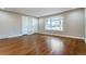 Bright living room with hardwood floors, large bay window, and fresh paint at 5500 Holland Dr, Arvada, CO 80002