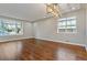 Well-lit living area featuring pristine hardwood floors, neutral paint, and bright windows at 5500 Holland Dr, Arvada, CO 80002