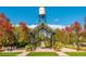 Charming town square featuring beautiful fall colors, a covered walkway, and manicured landscaping at 5500 Holland Dr, Arvada, CO 80002