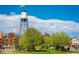 Scenic view of the water tower in Olde Town Arvada with vibrant fall foliage and lush greenery at 5500 Holland Dr, Arvada, CO 80002