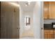 Apartment entryway featuring a wooden door, neutral carpet, and view of the living room at 850 20Th St # 201, Boulder, CO 80302