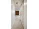 Hallway with storage closet and a view of the carpeted living room with brick accent wall at 850 20Th St # 201, Boulder, CO 80302