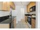 Kitchen featuring wood cabinets, black countertops and stainless steel appliances at 850 20Th St # 201, Boulder, CO 80302