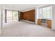 Bright living room with a sliding glass door to a balcony and a brick accent wall at 850 20Th St # 201, Boulder, CO 80302