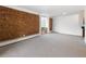 Spacious living room featuring a brick wall with neutral carpet and natural light at 850 20Th St # 201, Boulder, CO 80302