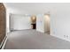 Open living area featuring a brick accent wall and access to the kitchen at 850 20Th St # 201, Boulder, CO 80302