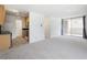 Open living space with a neutral palette, sliding glass doors to a balcony, and a connected kitchen at 850 20Th St # 201, Boulder, CO 80302