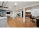 Finished basement with laminate flooring and access to storage areas at 3725 S Acoma St, Englewood, CO 80110