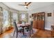 Charming dining room featuring a round table, hardwood floors, and bay windows at 3725 S Acoma St, Englewood, CO 80110