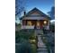 Quaint home with a welcoming porch, featuring soft exterior lighting and a landscaped front yard at 3725 S Acoma St, Englewood, CO 80110