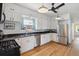 Bright kitchen with stainless steel appliances, granite countertops and white cabinets at 3725 S Acoma St, Englewood, CO 80110