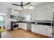 Bright kitchen featuring white cabinetry, stainless steel appliances, and hardwood floors at 3725 S Acoma St, Englewood, CO 80110