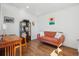 Cozy living room featuring a modern orange sofa, and hardwood floors at 3725 S Acoma St, Englewood, CO 80110