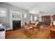 Inviting living room with hardwood floors, a decorative fireplace, and a dining area at 3725 S Acoma St, Englewood, CO 80110
